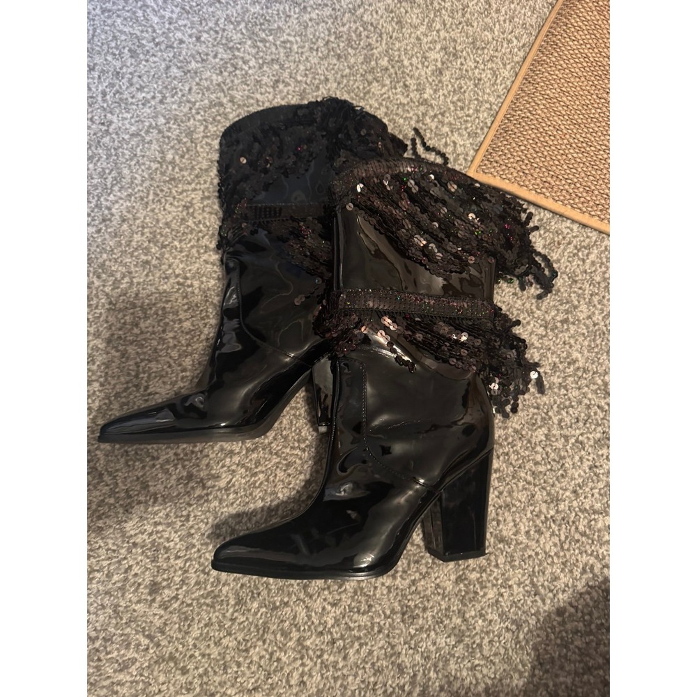 Black patent leather high heel boots with sequined fringe—bold, shiny